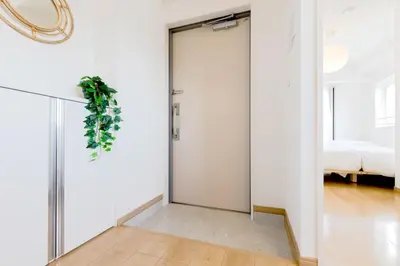 a sliding glass door in a room with a bedroom at Emilio Nishi Shinjuku in Tokyo