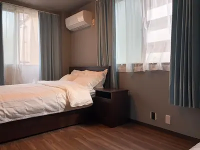 a small bedroom with a bed and a window at \u4e09\u30ce\u8f2a301 in Tokyo