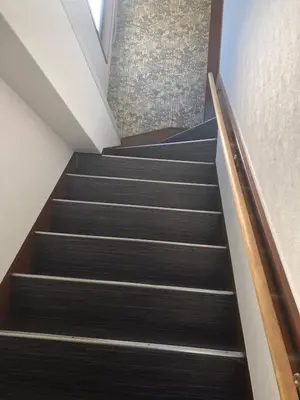 a staircase in a building with black stairs at \u4e09\u30ce\u8f2a301 in Tokyo