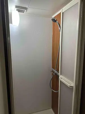 a shower in a bathroom with a glass door at \u4e09\u30ce\u8f2a301 in Tokyo