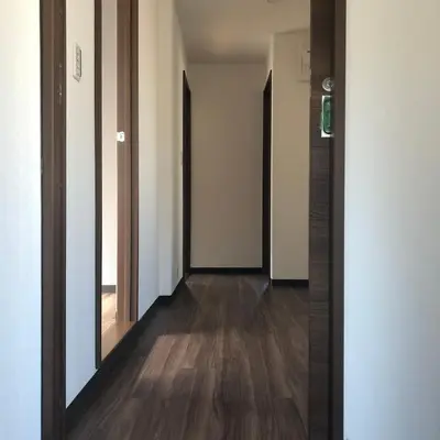 a hallway with two mirrors and a wooden floor at \u4e09\u30ce\u8f2a301 in Tokyo