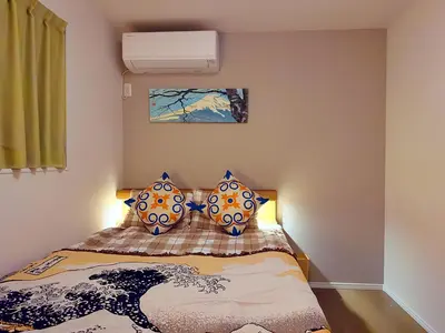 a bedroom with a bed with pillows on it at Hao Bros Home Gemini A in Tokyo