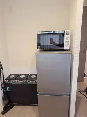 a laptop computer sitting on top of a refrigerator at Tulip Asakusa in Tokyo