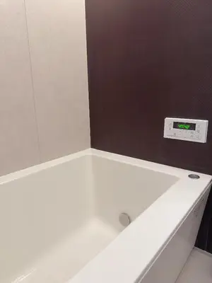 a white bath tub with a mirror on the wall at Tulip Asakusa in Tokyo