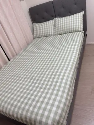 a bed with a green and white checkered mattress at Tulip Asakusa in Tokyo
