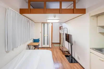 a small room with a bed and a chair at T s\u30cf\u30a4\u30e0 in Tokyo