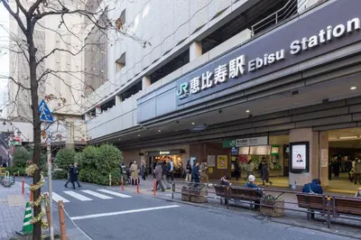 a street with people walking in front of a store at T s\u30cf\u30a4\u30e0 in Tokyo