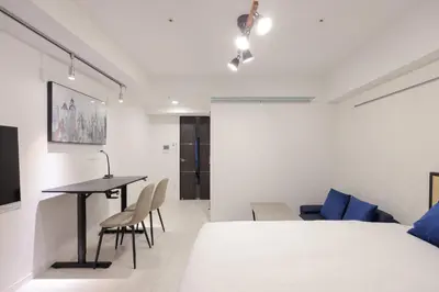 a bedroom with a bed and a table and chairs at AlTERNA\u6075\u6bd4\u5bff in Tokyo