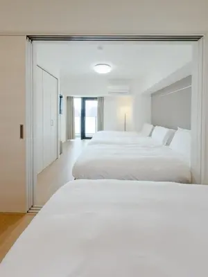 a bedroom with two beds and a large mirror at Asakusa 701 Quad Room in Tokyo