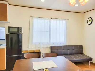 a living room with a couch and a table at \u6771\u9577\u5d0e\u6238\u5efa\u3066 \u6771\u9577\u5d0e\u99c5\u304b\u3089\u5f92\u6b692\u5206 in Tokyo