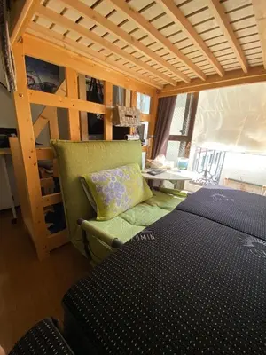 a bedroom with a bed and a bunk bed and a couch at A Cosy Daikanyama Stay at the Anime Sanctuary in Tokyo