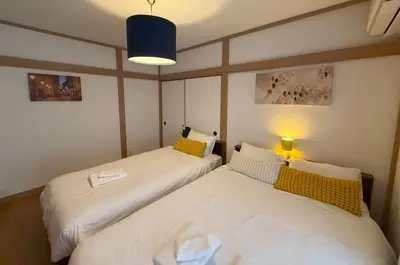 two beds in a small room with a lamp at Shinkoiwa 3BR house in Tokyo
