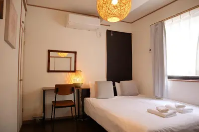 a bedroom with a bed and a desk and a window at Shinkoiwa 3BR house in Tokyo