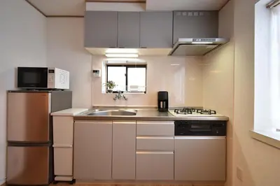 a small kitchen with a sink and a refrigerator at Shinkoiwa 3BR house in Tokyo
