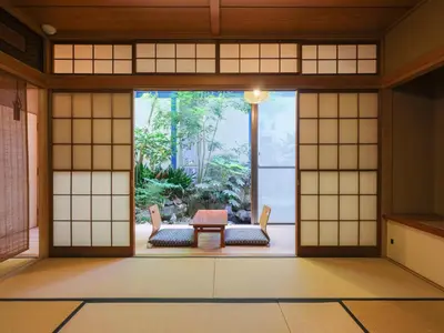 an open door to a room with a table and chairs at \u5343\u5e74\u90b8 in Tokyo