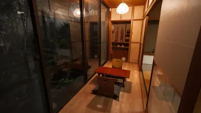 a room with a table and a glass wall at \u5343\u5e74\u90b8 in Tokyo