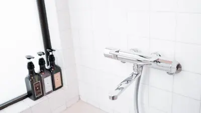 a bathroom with bottles of wine in a shower at \u5343\u5e74\u90b8 in Tokyo