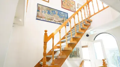 a staircase in a house with a painting on the wall at \u5343\u5e74\u90b8 in Tokyo