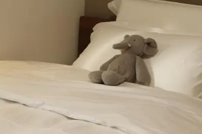 a teddy bear sitting on top of a bed at Asakusa 602 Triple Room in Tokyo