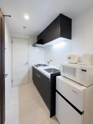 a kitchen with a sink and a microwave at Asakusa 602 Triple Room in Tokyo