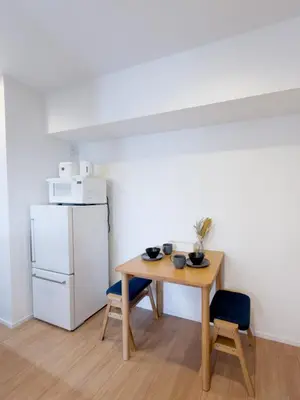a small kitchen with a table and a refrigerator at Asakusa 501 Quad room in Tokyo