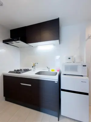 a kitchen with a sink and a microwave at Asakusa 502 Triple Room in Tokyo
