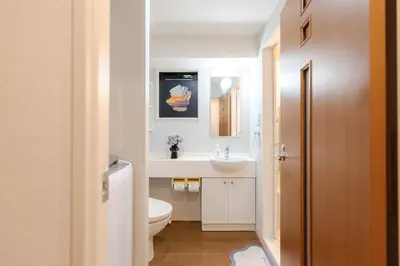 a bathroom with a white toilet and a sink at Shinjuku-IEE in Tokyo