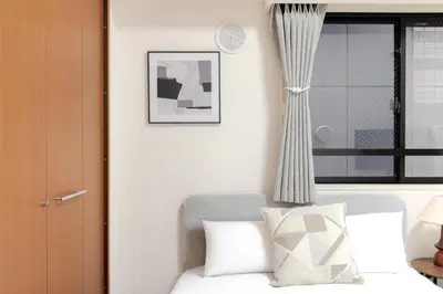 a bedroom with a white bed and a window at Shinjuku-IEE in Tokyo