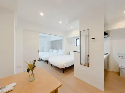 a hotel room with two beds and a table at Asakusa 401 Quad Room in Tokyo
