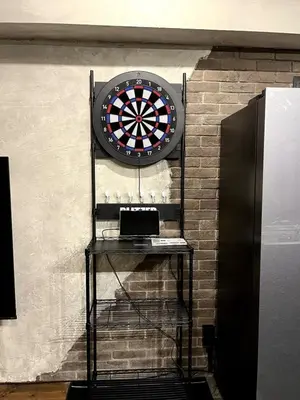a dart board on a wall with a shelf at ebo\u7d30\u5de5\u753a3\u4e01\u76ee4F in Tokyo