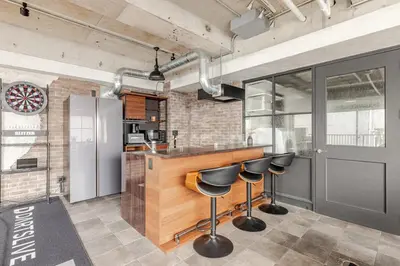 a kitchen with a bar and stools in a room at ebo\u7d30\u5de5\u753a3\u4e01\u76ee4F in Tokyo