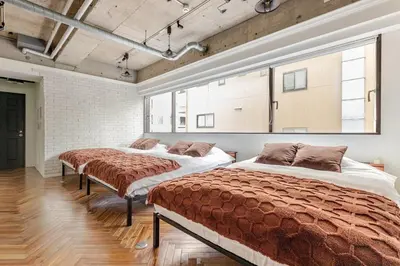 two beds in a large room with windows at ebo\u7d30\u5de5\u753a3\u4e01\u76ee4F in Tokyo
