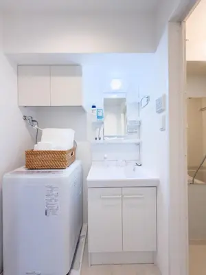 a white kitchen with a sink and a refrigerator at Asakusa 402 Triple Room in Tokyo