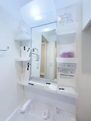 a white bathroom with a mirror and a sink at Asakusa 402 Triple Room in Tokyo