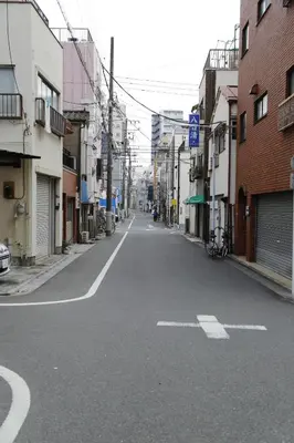 an empty street in an alley between buildings at Asakusa 301 Quad room in Tokyo