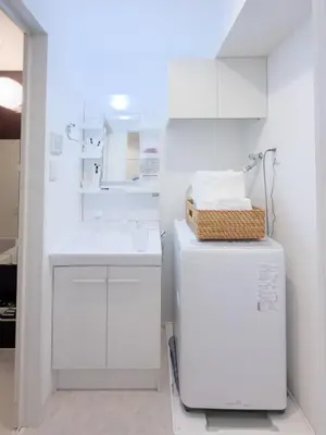 a white bathroom with a sink and a refrigerator at Asakusa 301 Quad room in Tokyo