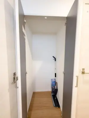 a hallway with an open door with an umbrella at Asakusa 201 Quad room in Tokyo