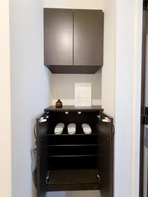 a kitchen with a black cabinet and a shelf at Asakusa 201 Quad room in Tokyo