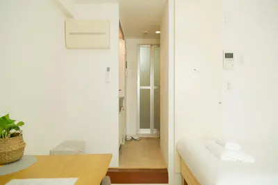a room with a bed and a desk and a hallway at Ikebukuro Twin Room in Tokyo