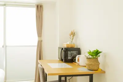 a table with a microwave and a coffee maker on it at Ikebukuro Twin Room in Tokyo