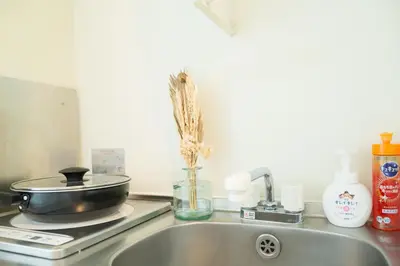 a kitchen counter with a sink and a pan on a stove at Ikebukuro 507 Twin Room in Tokyo