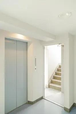 an empty hallway with a staircase and a glass door at Ikebukuro 507 Twin Room in Tokyo