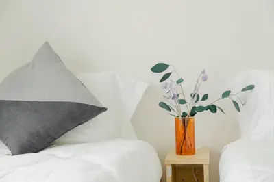 a vase with purple flowers sitting on a bed at Ikebukuro 507 Twin Room in Tokyo