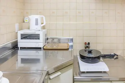 a kitchen counter with a stove and a microwave at Near skytree direct ueno asakusa,,baby bed,baby chair in Tokyo