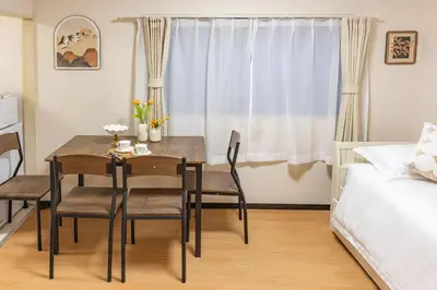 a dining room with a table and chairs and a bed at Near skytree direct ueno asakusa,,baby bed,baby chair in Tokyo