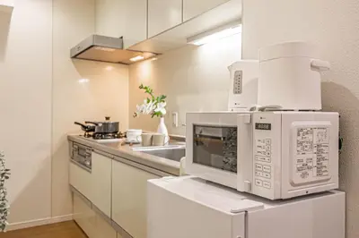 a kitchen with two microwaves on top of a counter at Near skytree direct ueno asakusa,,baby bed,baby chair in Tokyo