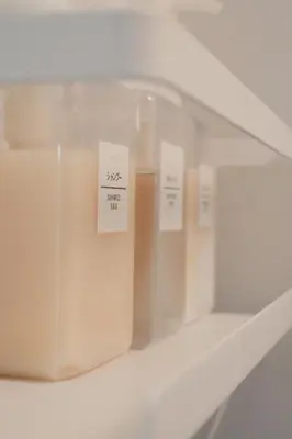 a shelf with three candles in a glass case at Ikeda Ueno 301 Twin Room in Tokyo