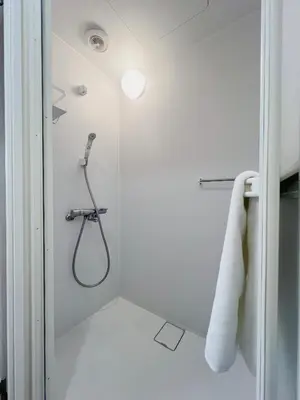 a bathroom with a shower with a hose at Ikeda Ueno 301 Twin Room in Tokyo