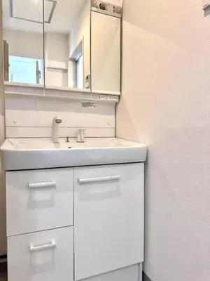 a white bathroom with a sink and a mirror at Ikeda Ueno 401 Quad room in Tokyo