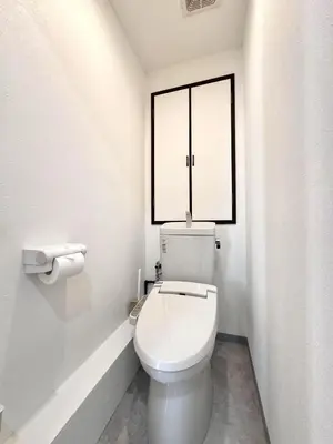 a white toilet in a bathroom with a window at Ikeda Ueno 501 Quad room Room in Tokyo